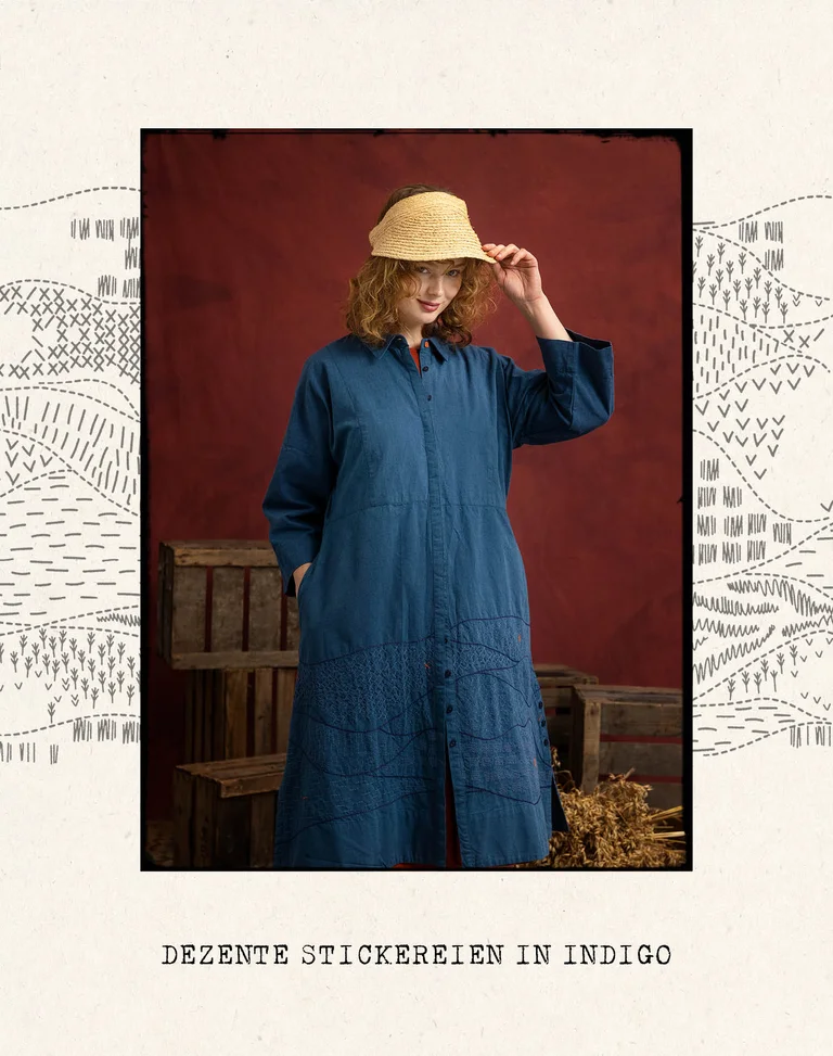 A woman in a blue woven dress with embroidery from Gudrun Sjödén.