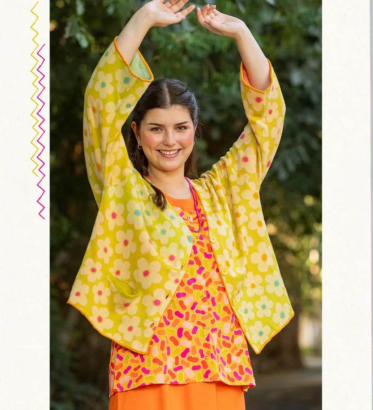 A woman wearing a floral-patterned cardigan from Gudrun Sjödén.