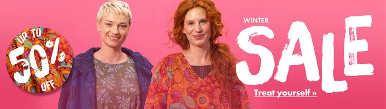 Two women wearing colourful clothes from Gudrun Sjödén.