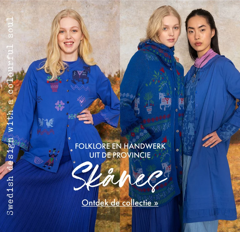 A collage with three photos of: two women wearing folk-art patterned clothes, a close-up of a woman wearing a blue knitted balaclava with a floral pattern, and a woman wearing a blue embroidered blouse and blue skirt from Gudrun Sjödén. A painted autumnal landscape is visible in the background.