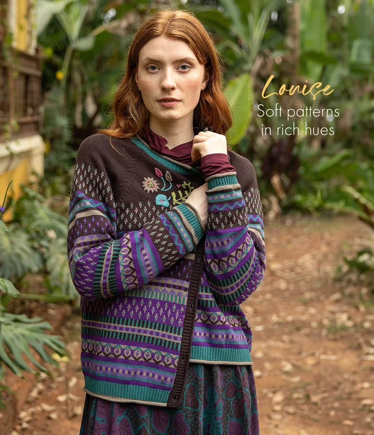 A woman wearing a patterned cardigan from Gudrun Sjödén. 