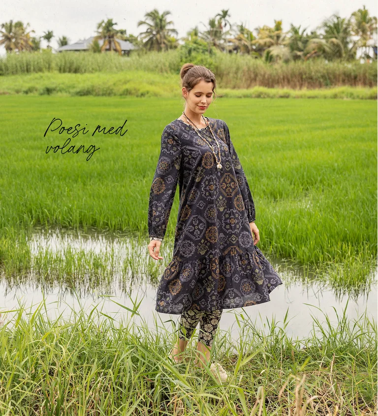 A woman wearing a checked dress from Gudrun Sjödén. 