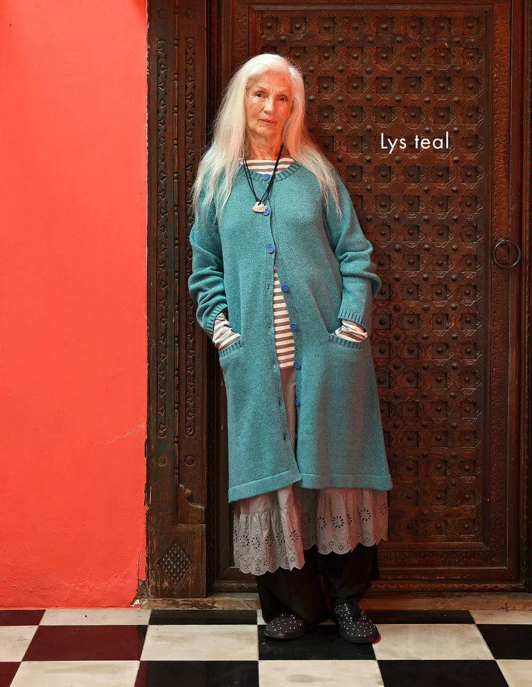 A woman wearing a blue cardigan from Gudrun Sjödén.