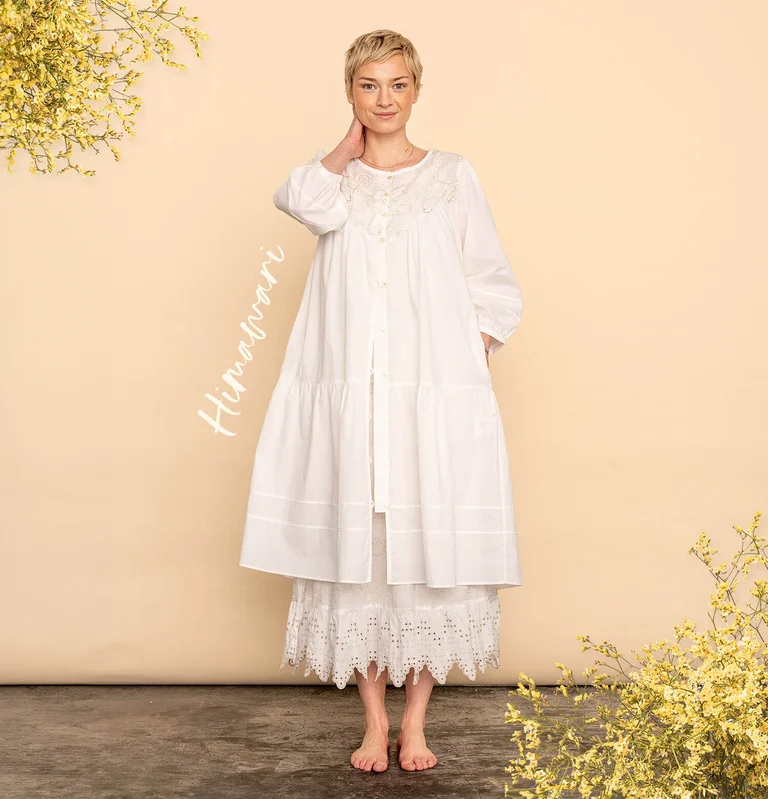 A woman wearing a white dress from Gudrun Sjödén. 