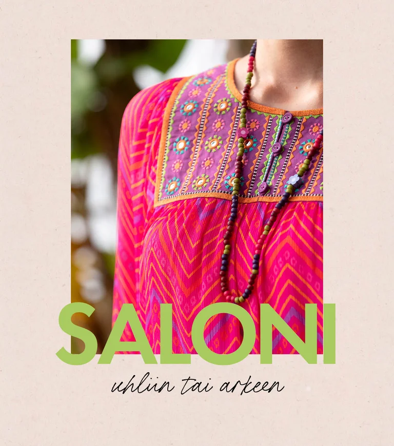 A woman wearing a patterned dress and an open dress from Gudrun Sjödén. 