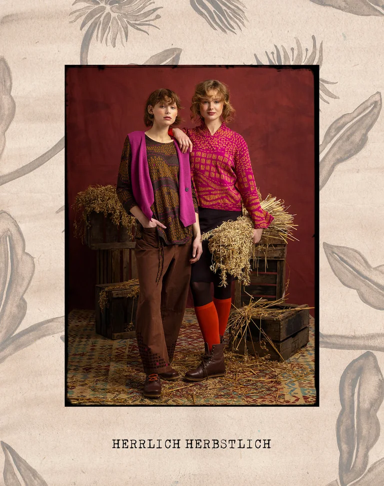 Two women next to each other wearing layers of clothing from Gudrun Sjödén.