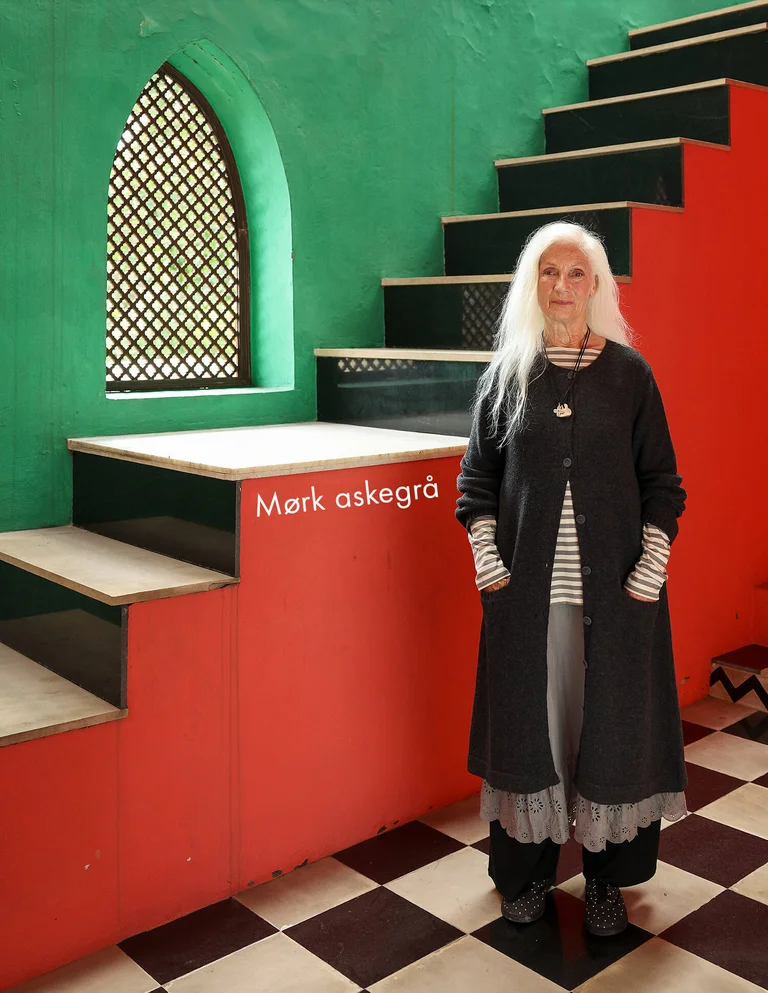 A woman wearing a dark gray cardigan from Gudrun Sjödén.