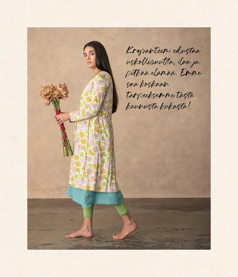 A woman wearing a floral-patterned dress from Gudrun Sjödén.