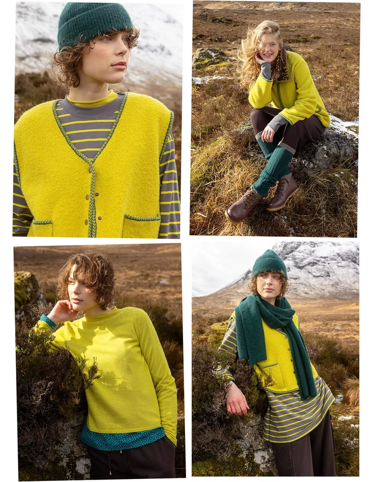 A woman wearing a yellow-green vest over a striped sweater and green hat from Gudrun Sjödén.