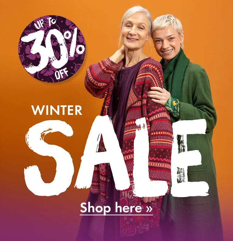 Two women wearing layers of colourful clothes from Gudrun Sjödén.