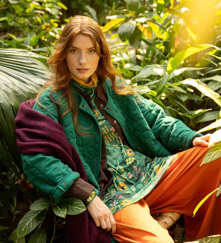 A woman wearing a green jersey jacket from Gudrun Sjödén.