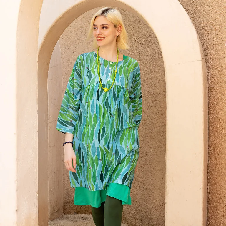 A woman wearing green, patterned clothes from Gudrun Sjödén’s Paris collection. 