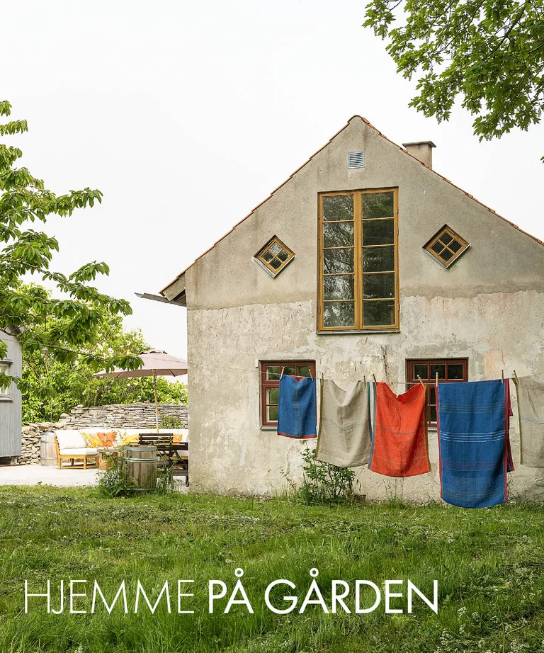 A lime-plastered house on Gotland with home textiles from Gudrun Sjödén on a clothesline.