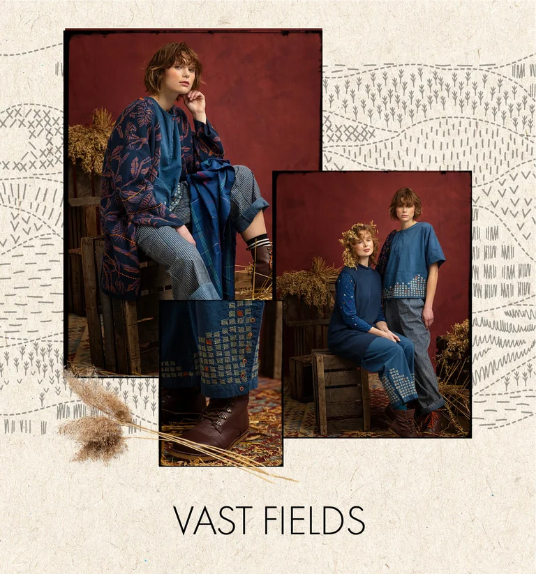 A woman wearing an embroidered woven indigo-blue dress from Gudrun Sjödén.