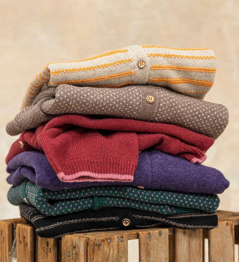 A pile of folded, knitwear from Gudrun Sjödén.