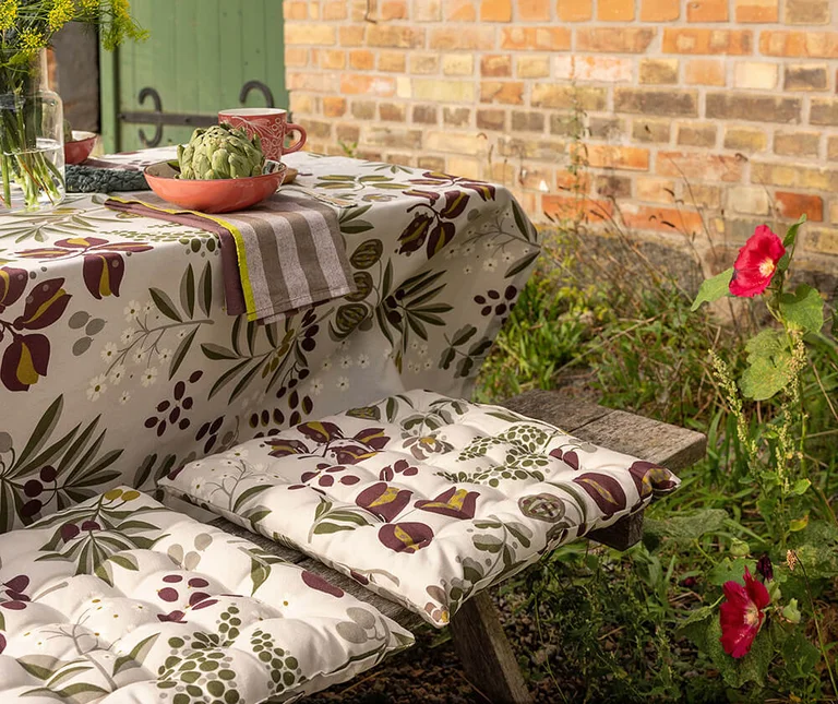 A table with patterned textiles from Gudrun Sjödén. 