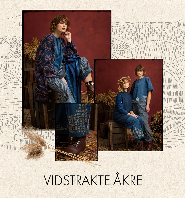 En kvinne kledd i en brodert vevd kjole i indigoblått fra Gudrun Sjödén.