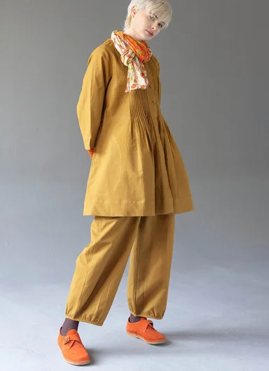 A woman wearing woven essentials from Gudrun Sjödén.