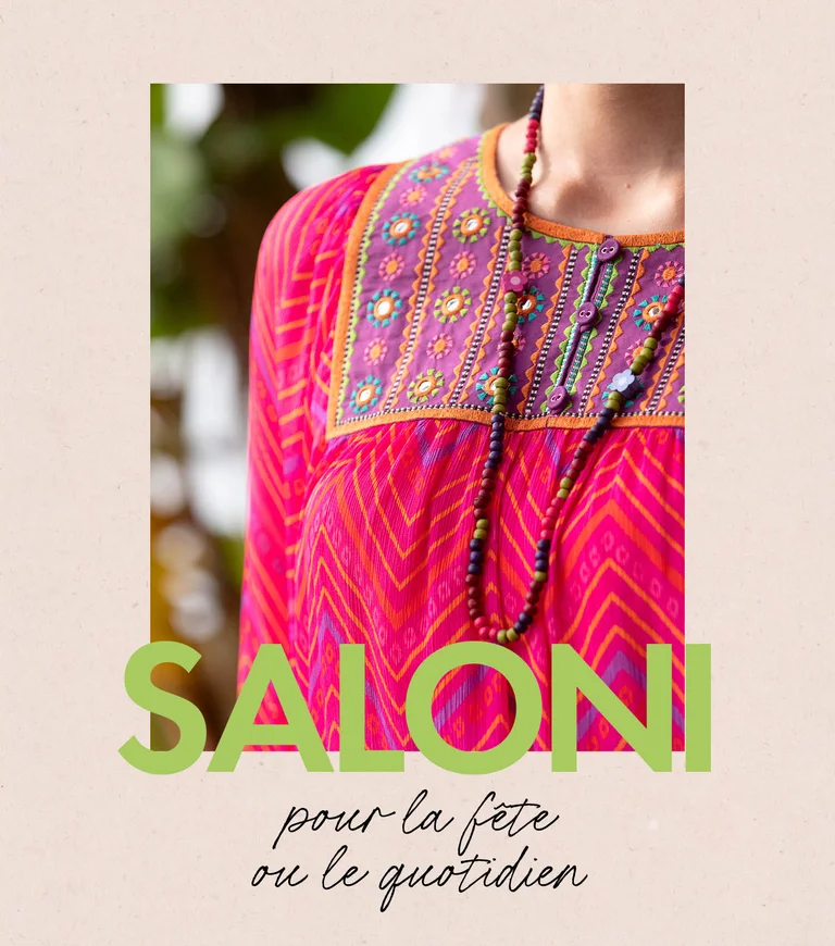 A woman wearing a patterned dress and an open dress from Gudrun Sjödén. 