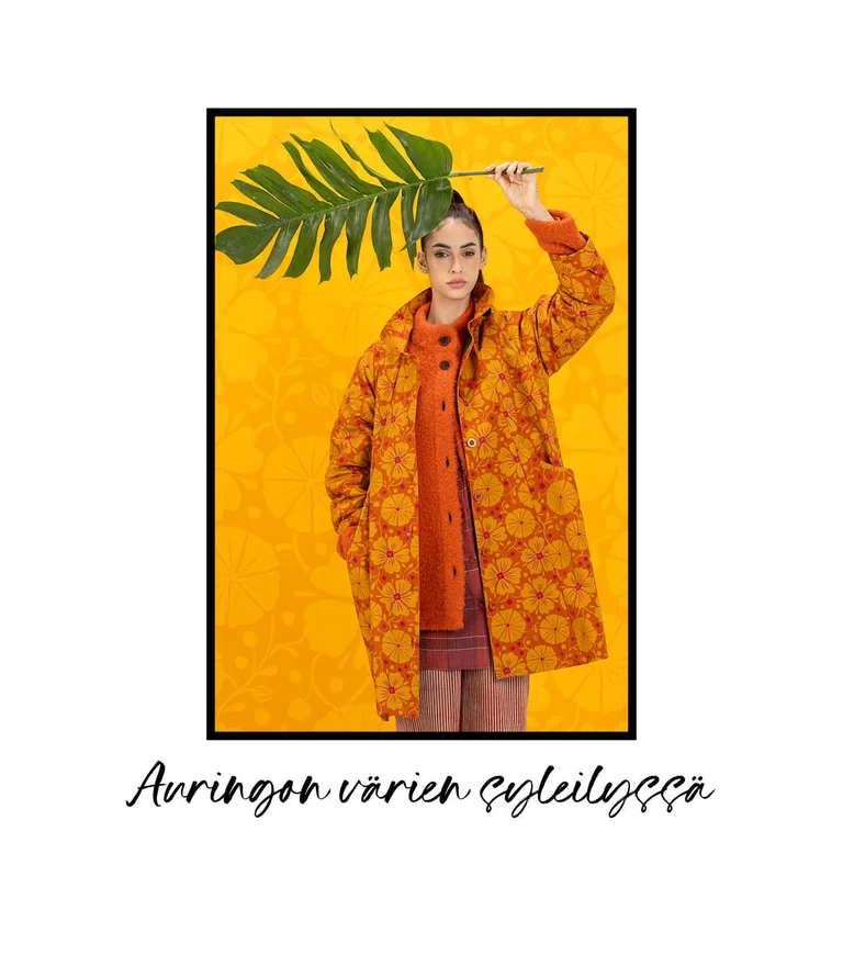 A woman wearing a patterned orange coat from Gudrun Sjödén. 