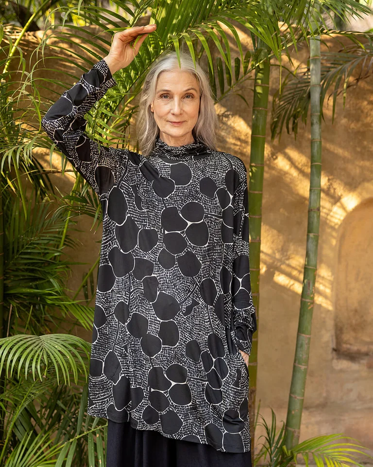 A woman wearing a black and white patterned jersey tunic from Gudrun Sjödén. 