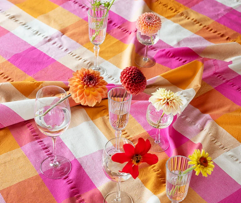 A table with a check tablecloth from Gudrun Sjödén. 