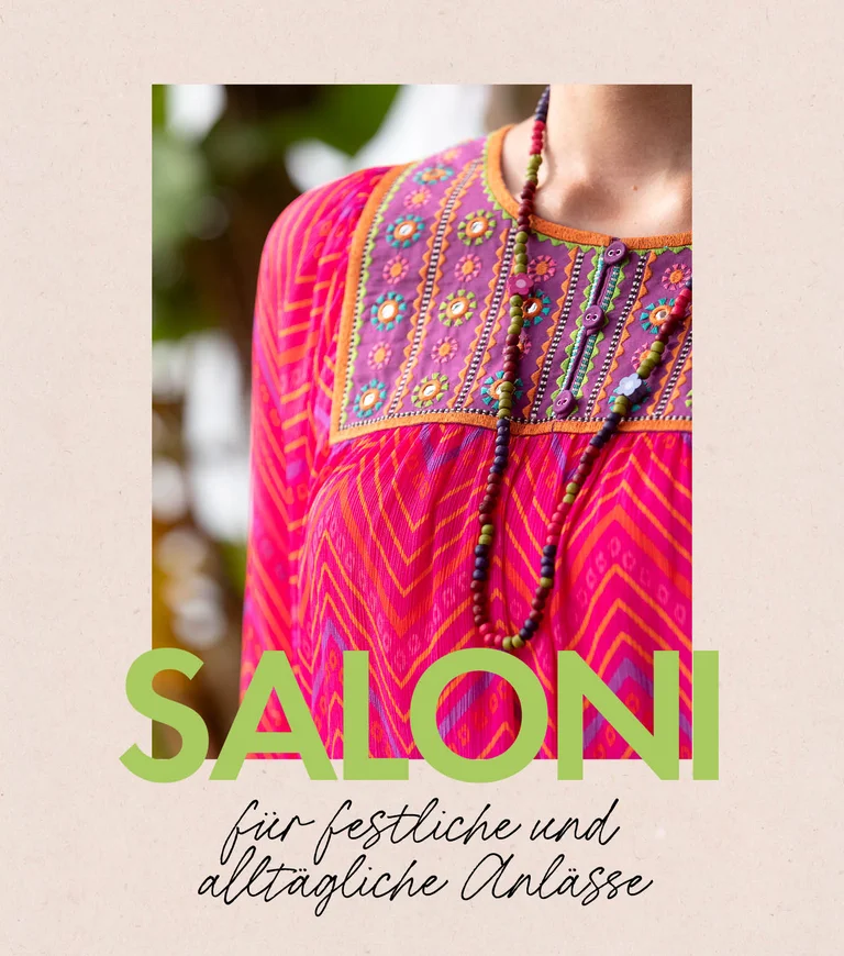 A woman wearing a patterned dress and an open dress from Gudrun Sjödén. 