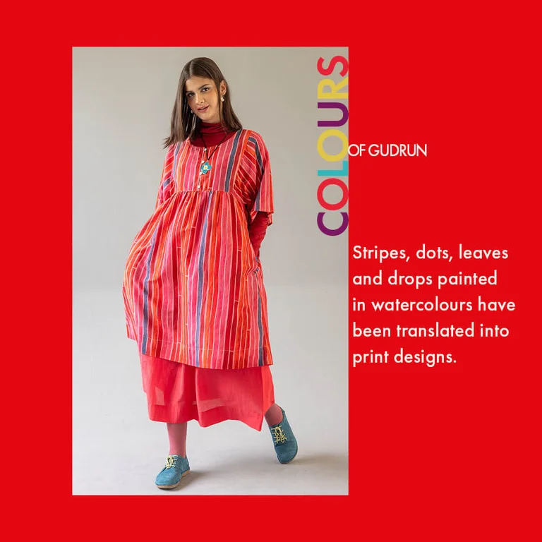 A red background overlaid with a picture of a woman wearing layers of clothes from Gudrun Sjödén’s Paris collection.