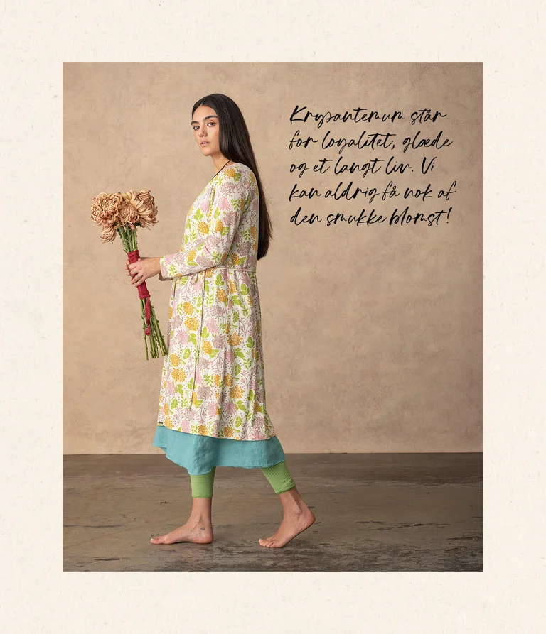A woman wearing a floral-patterned dress from Gudrun Sjödén.