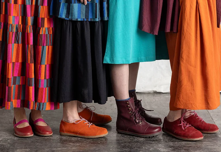 Four legs and feet wearing autumn footwear from Gudrun Sjödén. 
