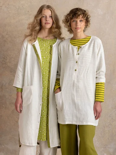 Two women standing next to each other wearing layers of essentials from Gudrun Sjödén.