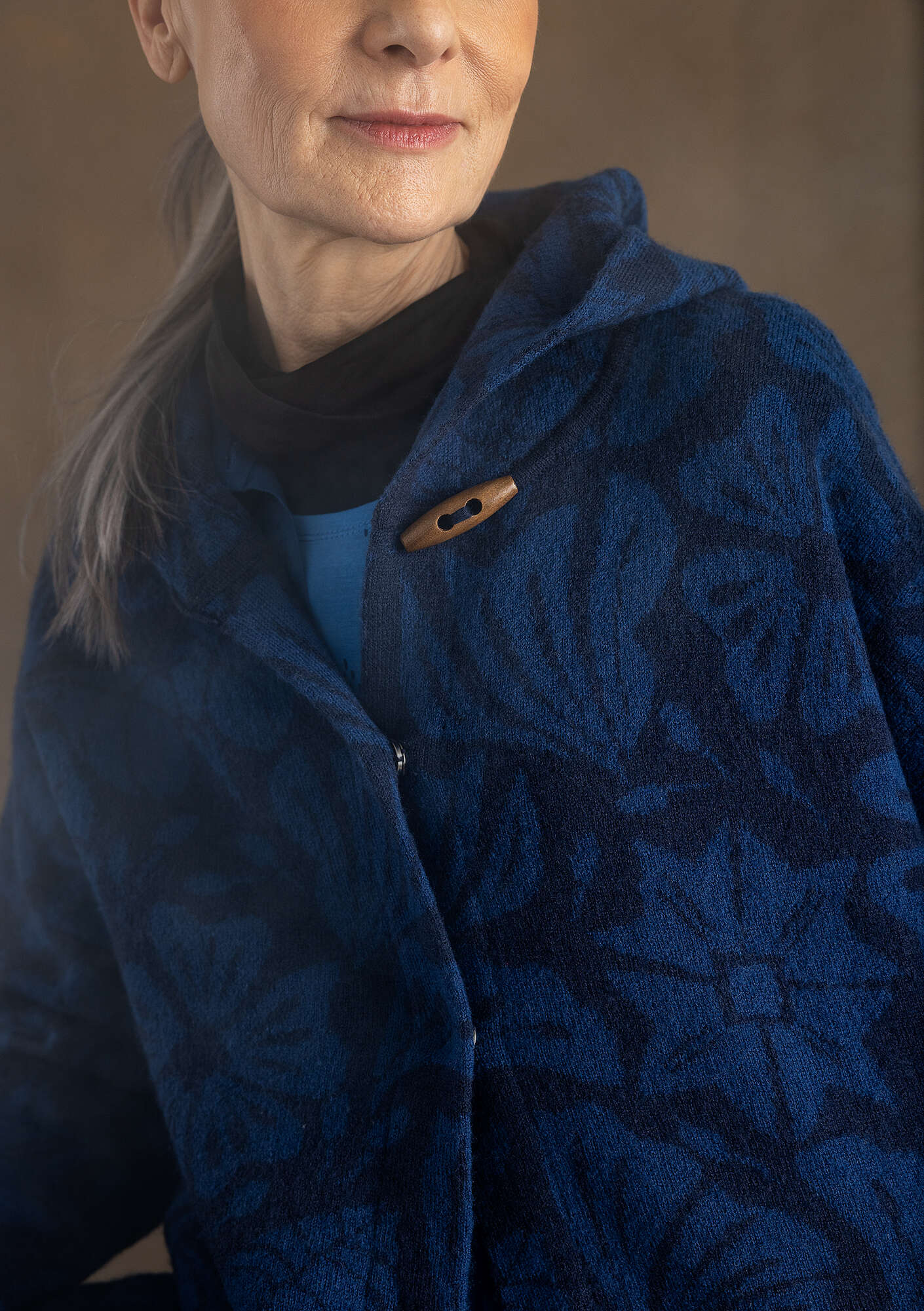 “Wind” knitted coat crafted from felted organic wool dark indigo thumbnail