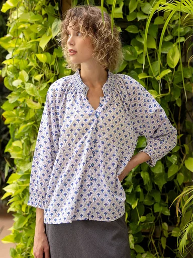 Three women next to each other wearing purple and blue patterned clothes from Gudrun Sjödén.