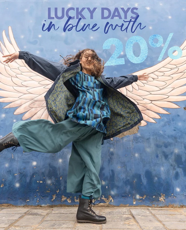 A woman wearing layers of blue clothing from Gudrun Sjödén. 
