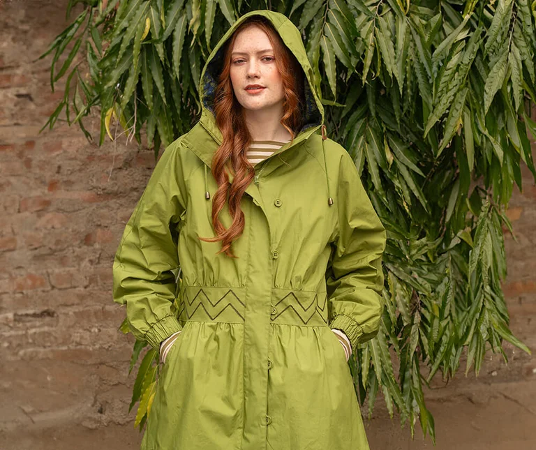 A woman wearing a green parka from Gudrun Sjödén. 