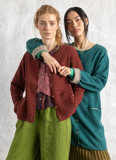A woman wearing a red knitted sweater from Gudrun Sjödén.