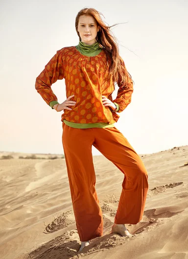 A woman wearing a patterned dress from Gudrun Sjödén. 