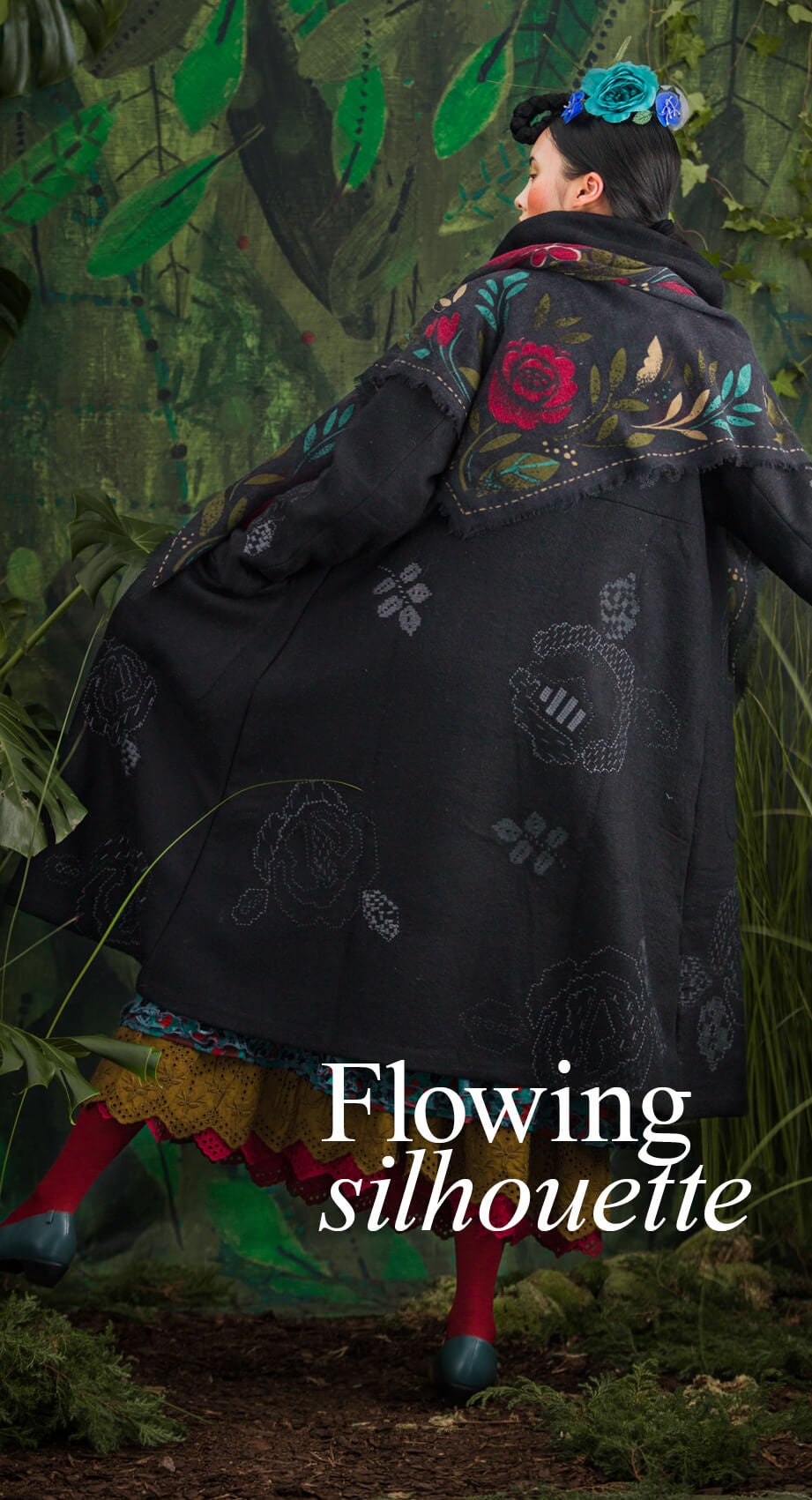 Large embroidered roses with a graphic look adorn this finely crafted coat. 