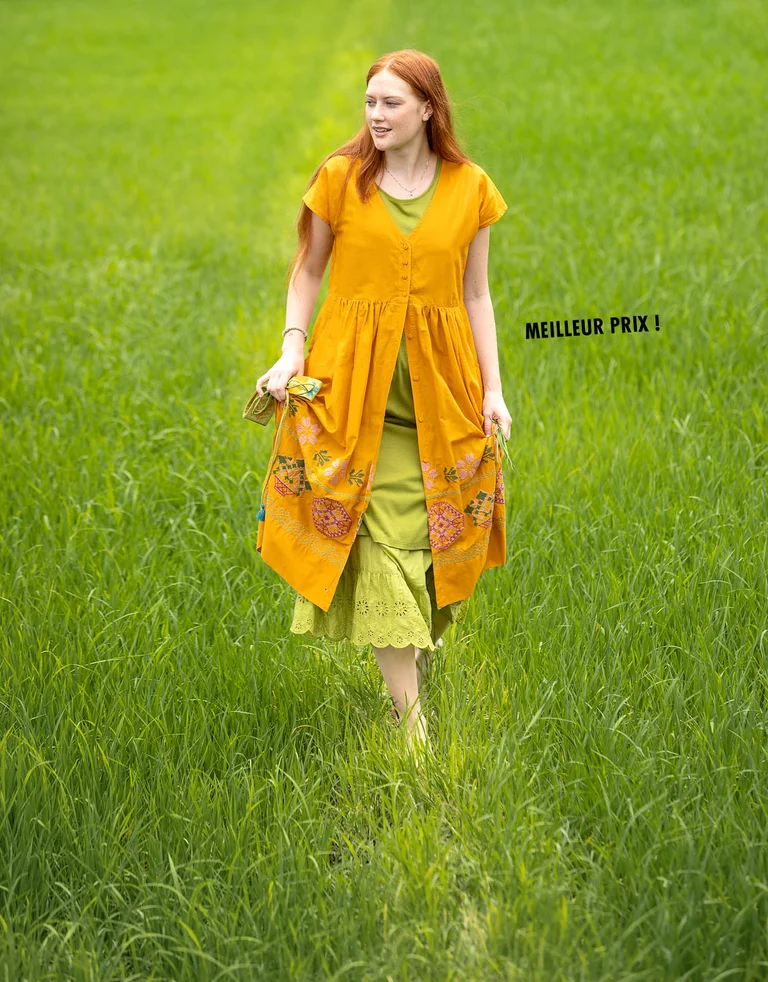 A woman wearing layers of clothing from Gudrun Sjödén.