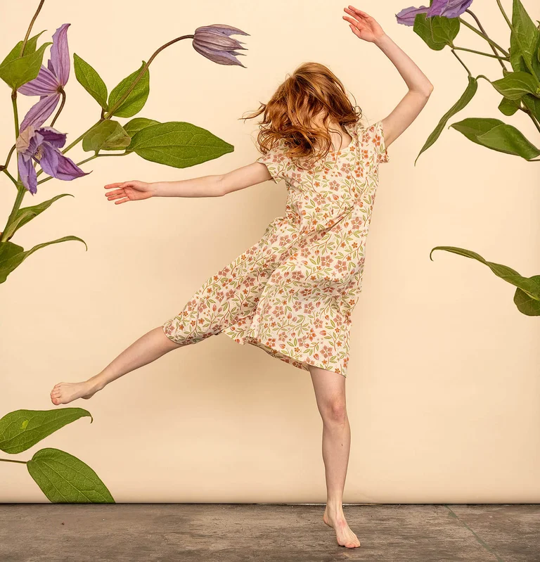 A woman wearing a floral dress from Gudrun Sjödén. 