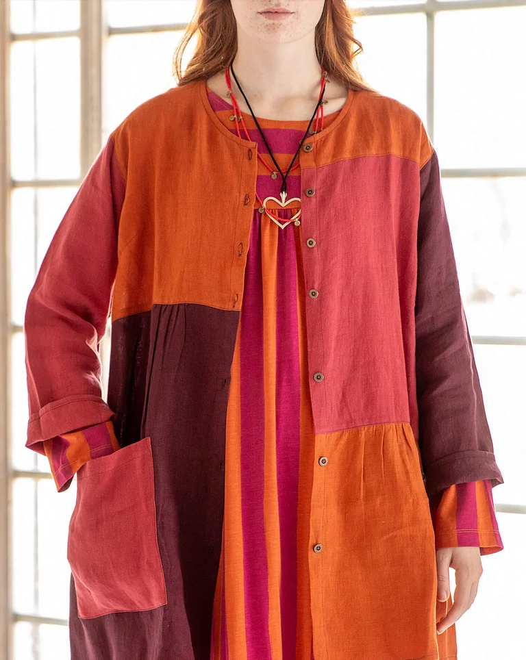 A woman wearing layers of colorful clothing from Gudrun Sjödén. 