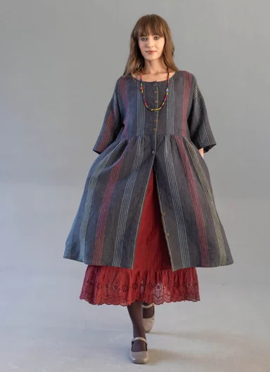 A woman wearing layers of woven clothes from Gudrun Sjödén.