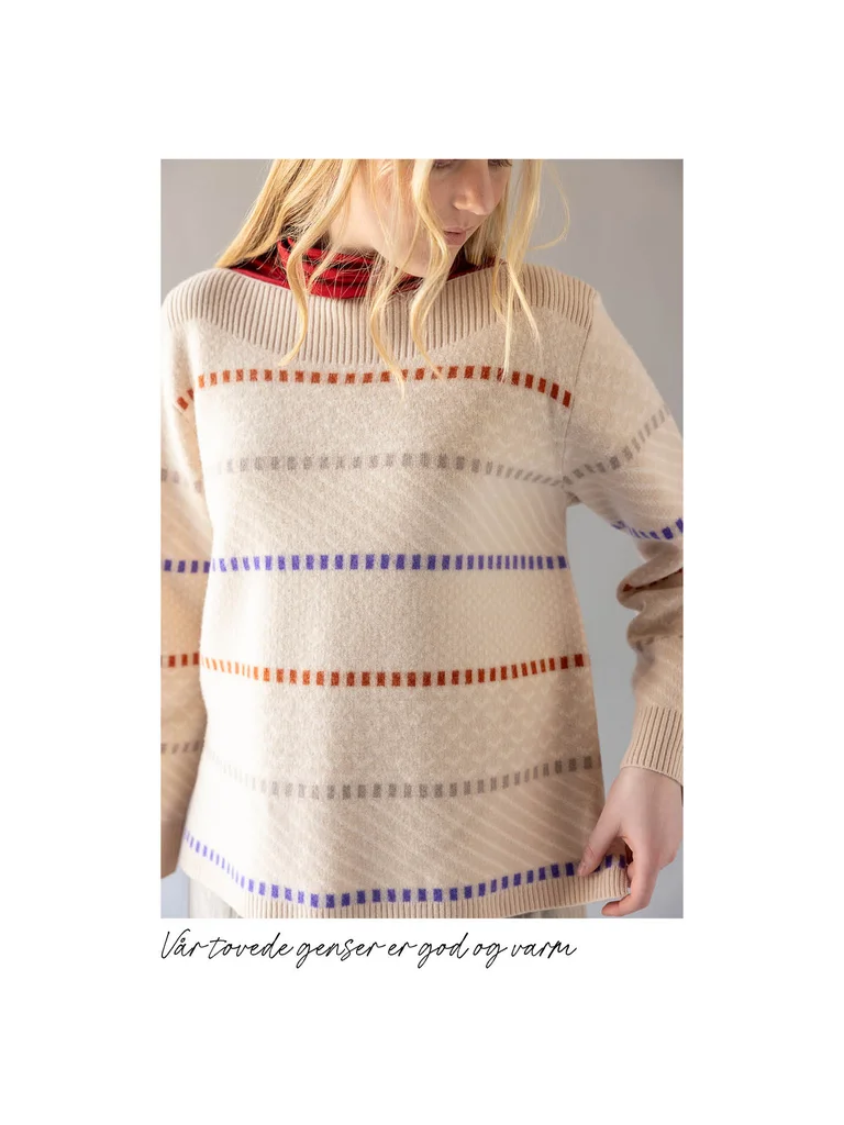 A close-up of a woman wearing a striped, white sweater from Gudrun Sjödén’s 2025 Christmas collection.