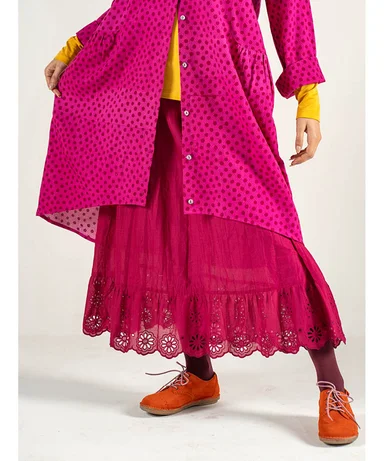 A lower body wearing a pink ruffle skirt from Gudrun Sjödén.