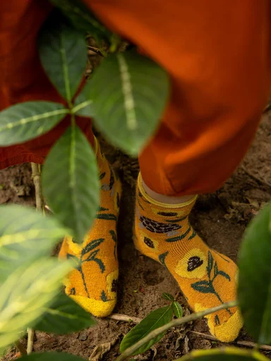 A woman wearing patterned yellow socks from Gudrun Sjödén. 