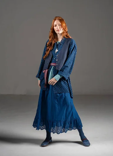 A woman wearing a patterned dress from Gudrun Sjödén. 
