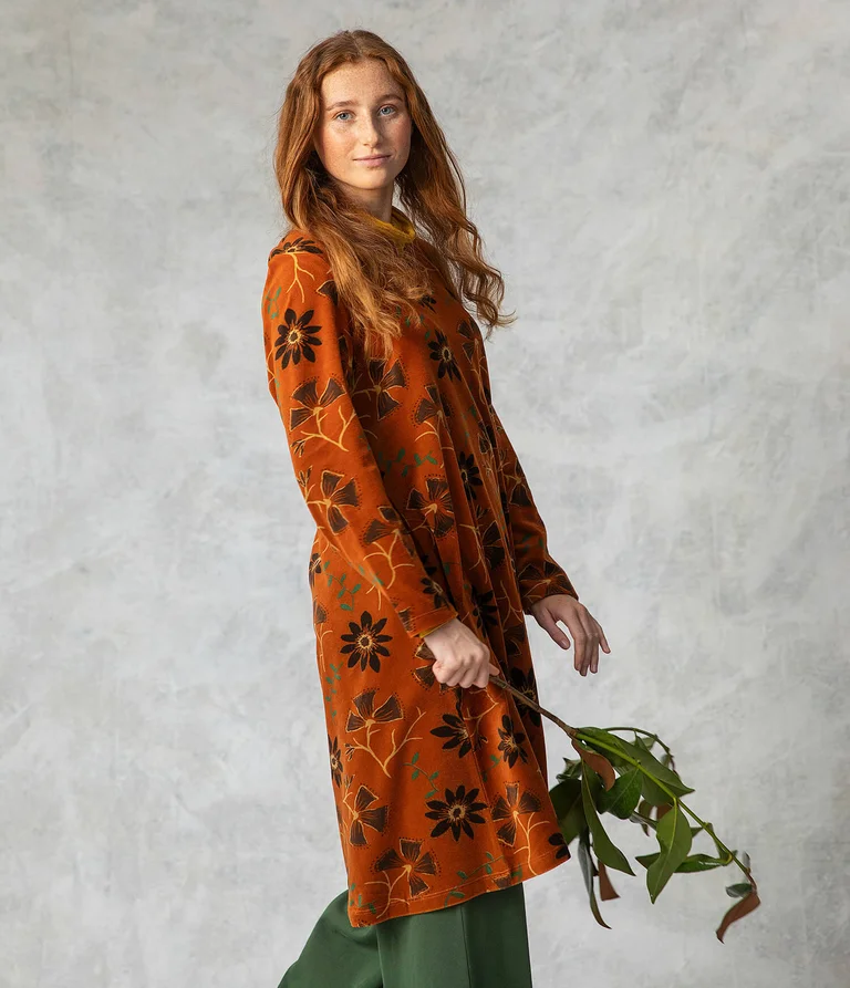 A woman wearing a floral velour dress from Gudrun Sjödén