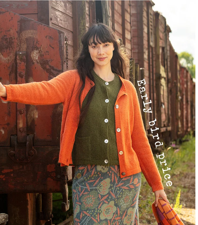 A woman wearing layers of knitted cardigans and a patterned skirt from Gudrun Sjödén.