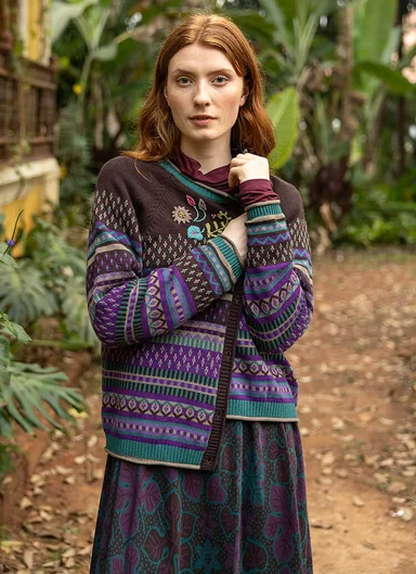 A woman wearing a patterned cardigan from Gudrun Sjödén. 