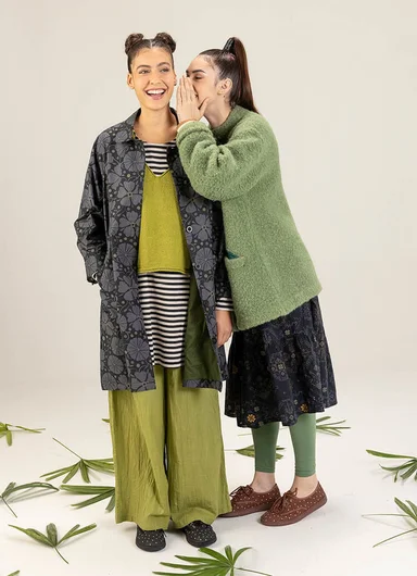 Two women posing next to each other wearing outerwear from Gudrun Sjödén.